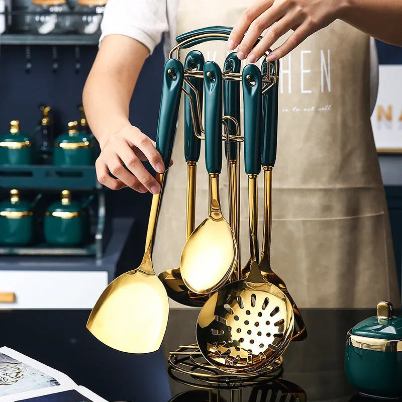 7-piece stainless steel kitchen utensil set with silicone handles showing slotted spatula, turner, ladle, serving spoon, and pasta server