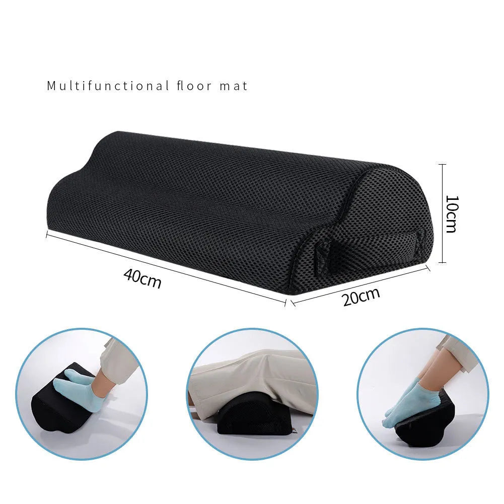 Black semi-circular foot rest pillow 40x20x10cm on floor under desk
