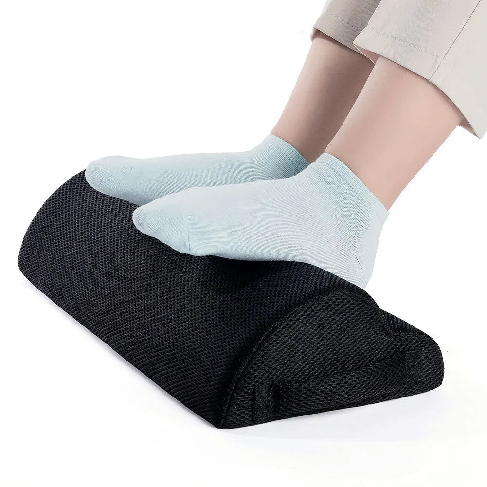 Black semi-circular foot rest pillow 40x20x10cm on floor under desk