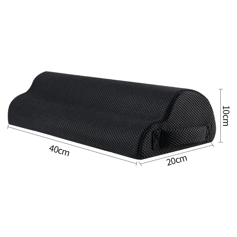 Black semi-circular foot rest pillow 40x20x10cm on floor under desk