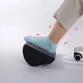Black semi-circular foot rest pillow 40x20x10cm on floor under desk
