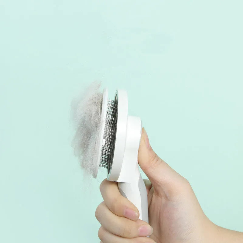 Self-cleaning pet comb with round handle and stainless steel sticky bead teeth in blue