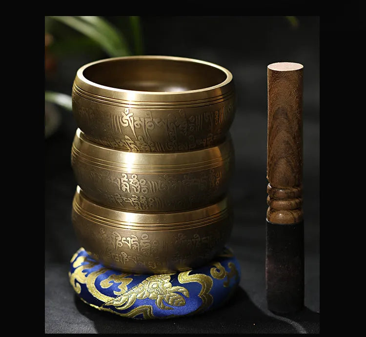 Handmade copper singing bowl with auspicious knot design on a soft surface with leather stick