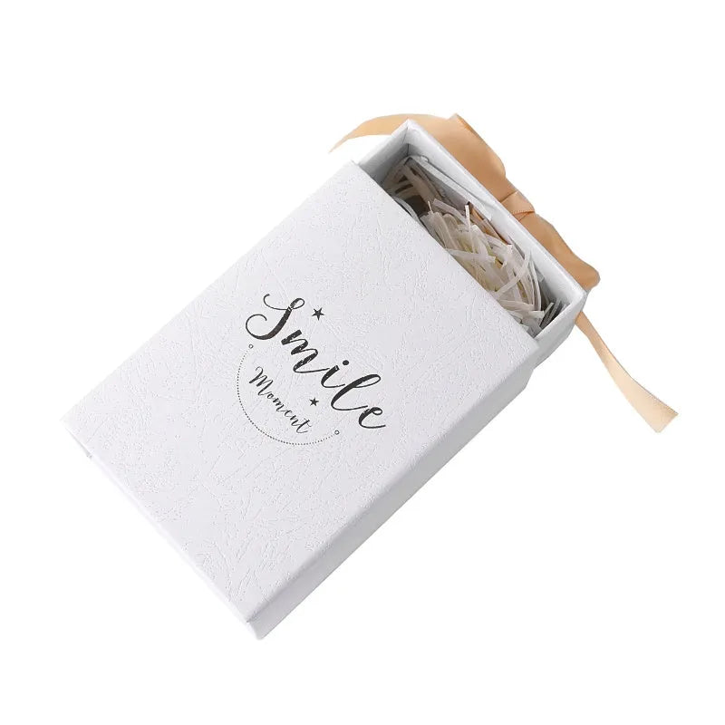 Small hard cardboard gift box with bronzing detail in blue, pink, red, and white colour options