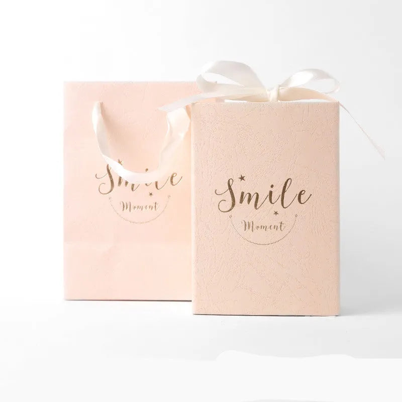 Small hard cardboard gift box with bronzing detail in blue, pink, red, and white colour options