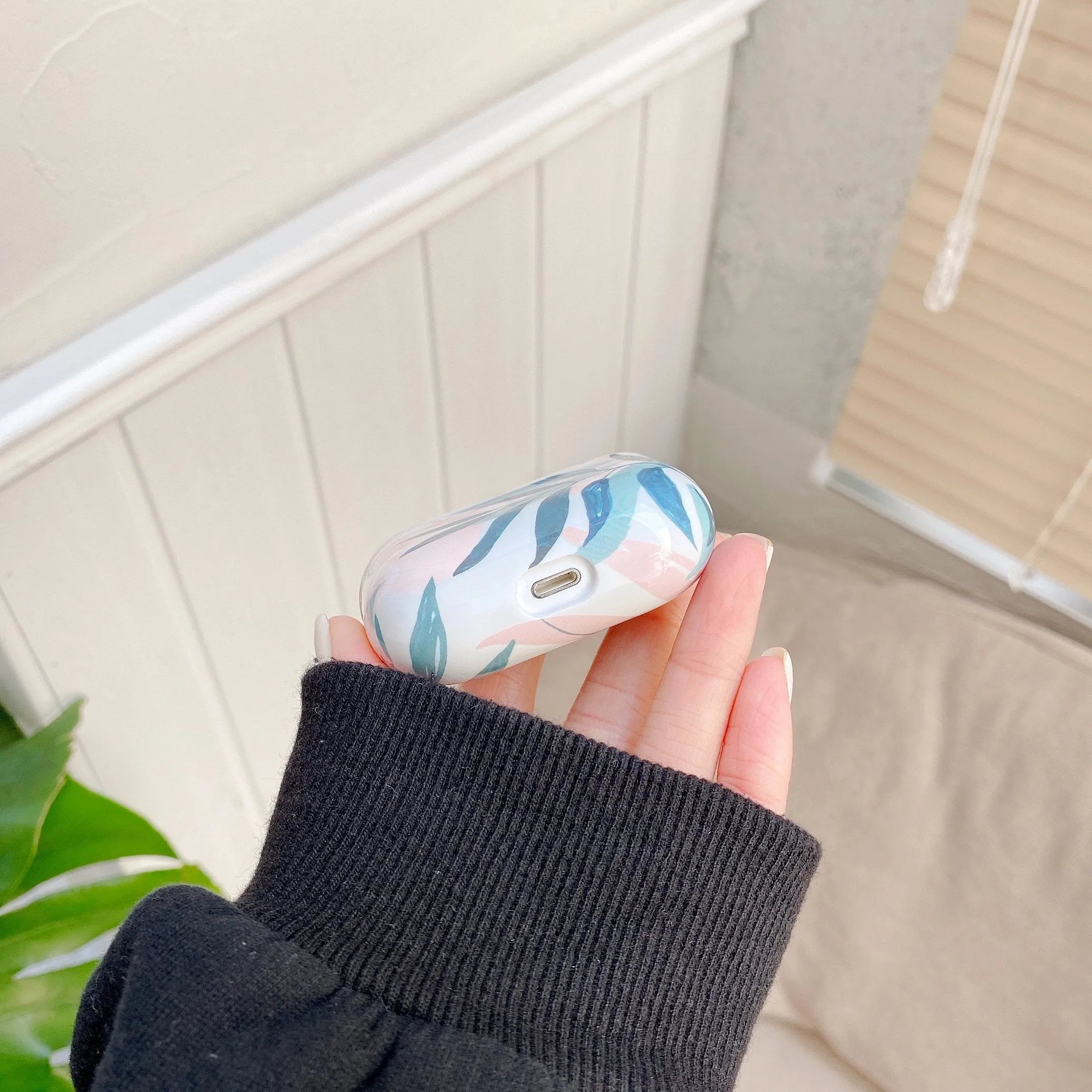 Blue and green TPU AirPods cases with a tropical banana leaf pattern design.