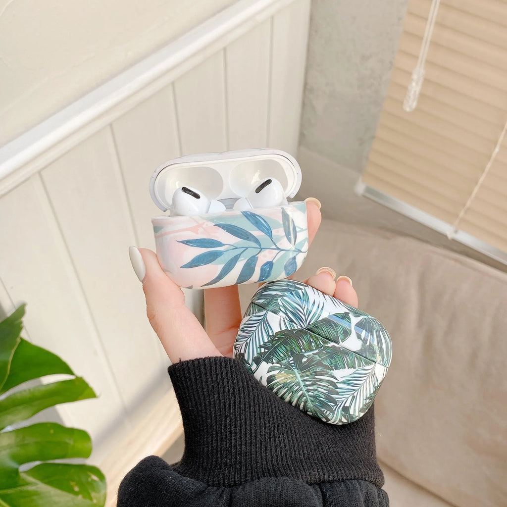 Blue and green TPU AirPods cases with a tropical banana leaf pattern design.