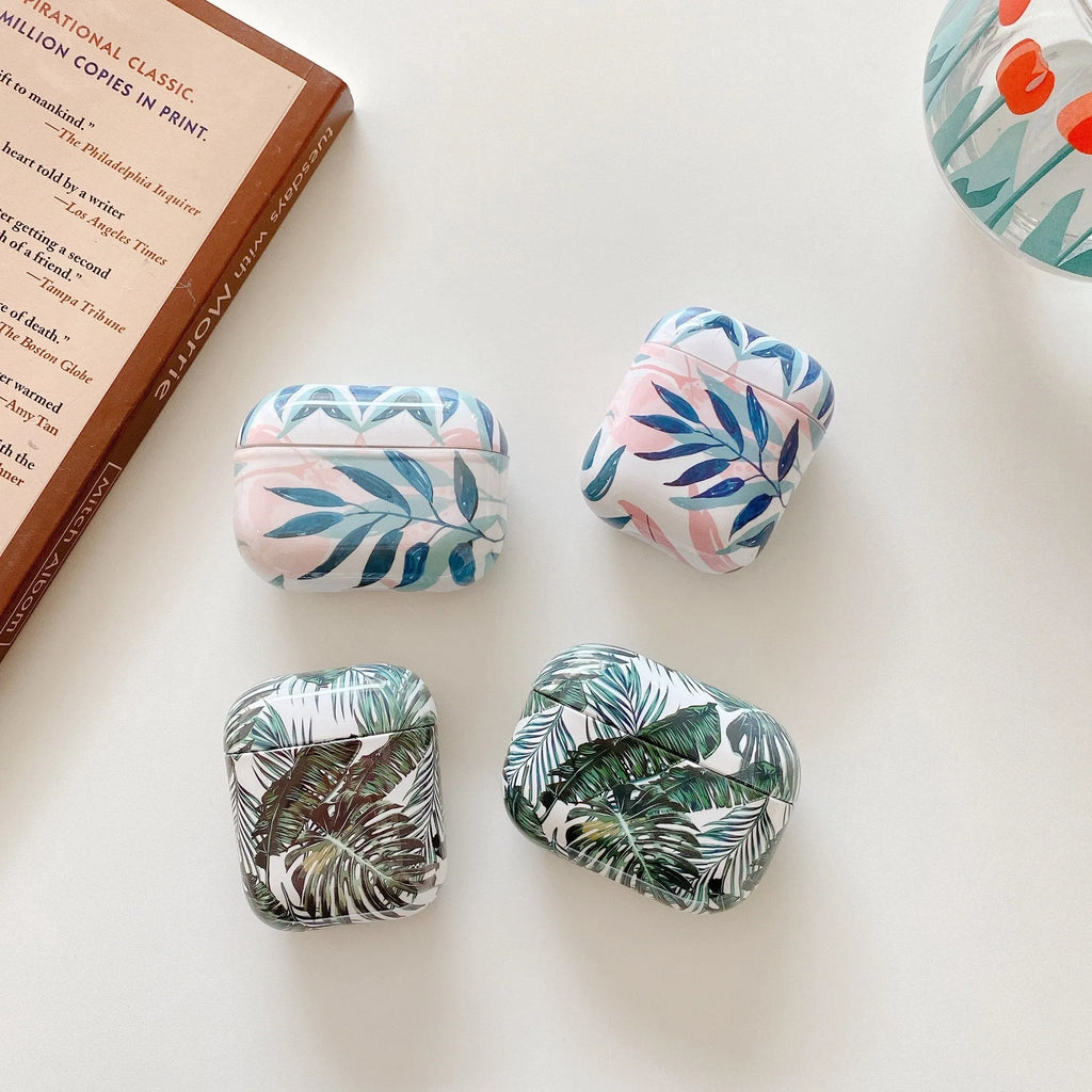 Blue and green TPU AirPods cases with a tropical banana leaf pattern design.