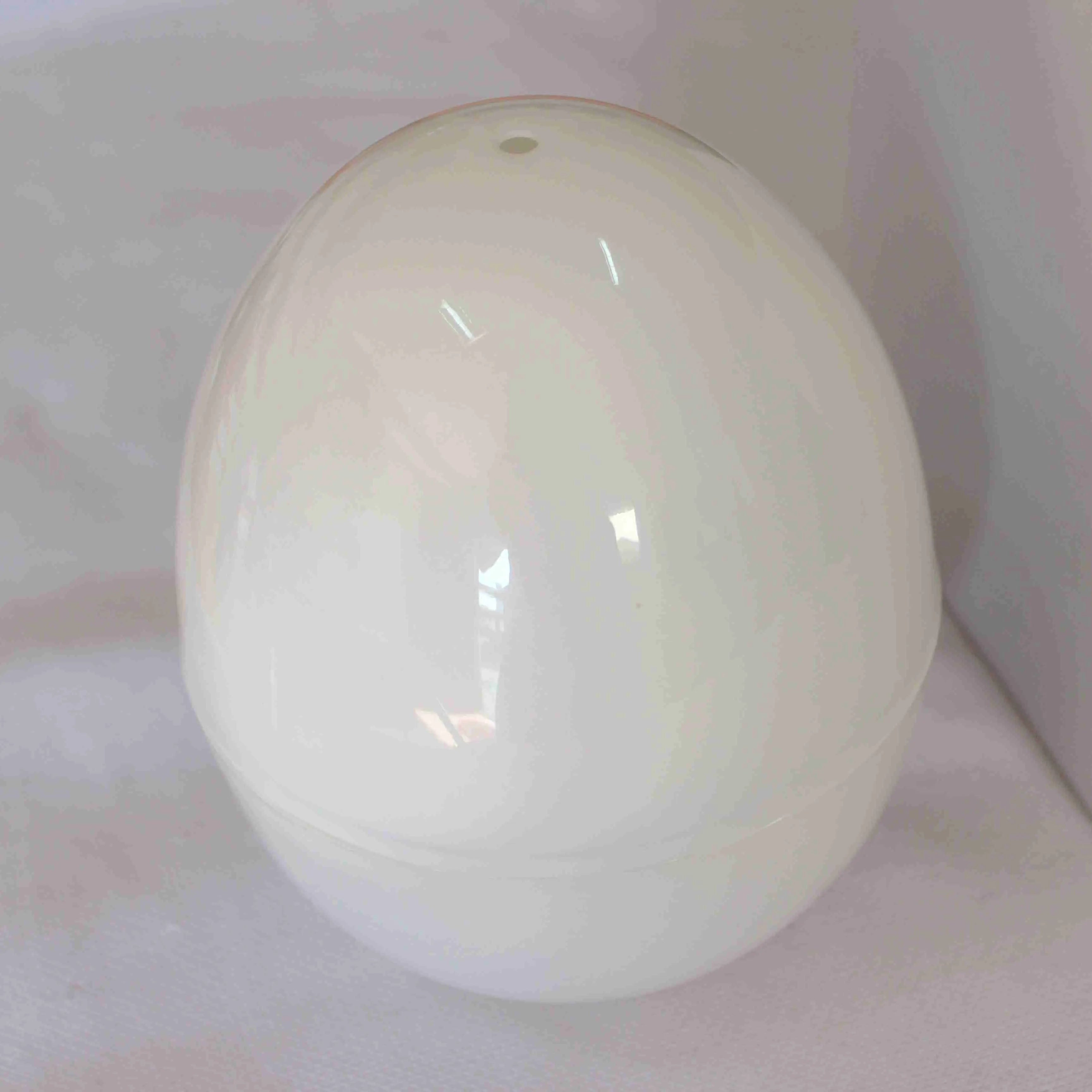 White microwave egg cooker for 4 eggs with adjustable timer knob and vent holes