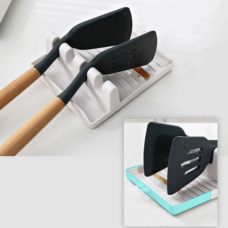 Green silicone 4-hole kitchen spatula holder with chopsticks and spoon on clean countertop