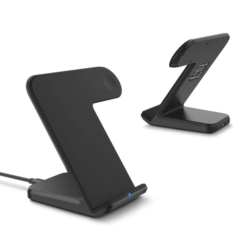 Black wireless charging pad for mobile phones on a wooden desk with a smartphone placed on top.