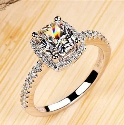 Silver alloy women's ring with artificial gemstone geometric design on white background