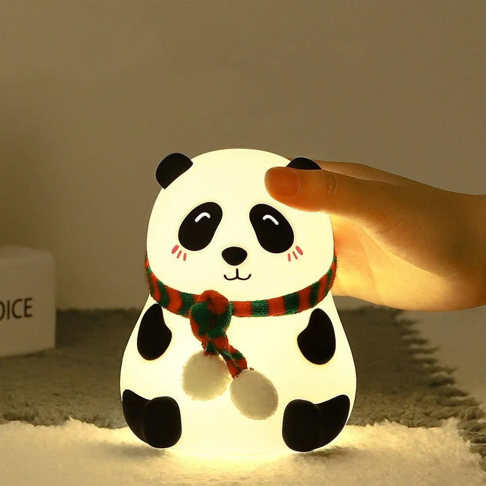 Panda-shaped silicone night light with USB cable on a wooden surface