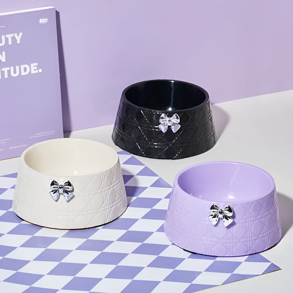 Ceramic pet bowl with diamond pattern and a bowknot decoration in pink, silver, black, purple, or white