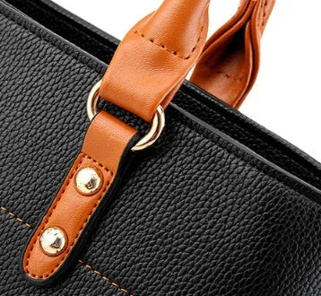 Women's PU leather crossbody shoulder bag in Black with silver-tone clasp, worn over shoulder