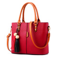 Women's PU leather crossbody shoulder bag in Black with silver-tone clasp, worn over shoulder