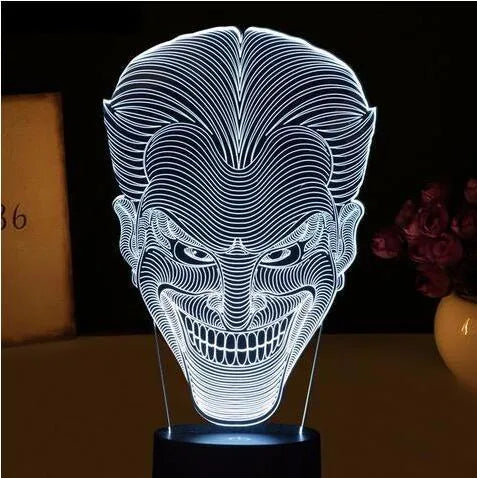 USB-powered 3D LED desk lamp showing multiple colour modes on an acrylic panel with a remote control.