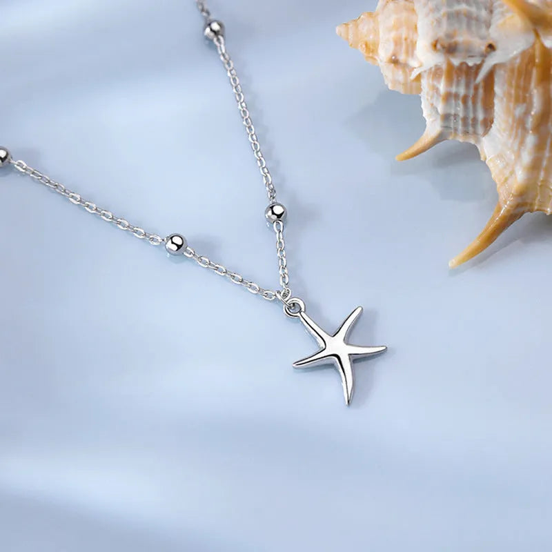 S925 sterling silver adjustable starfish anklet with round beads on an ankle, showing the 1.2 cm charm detail.