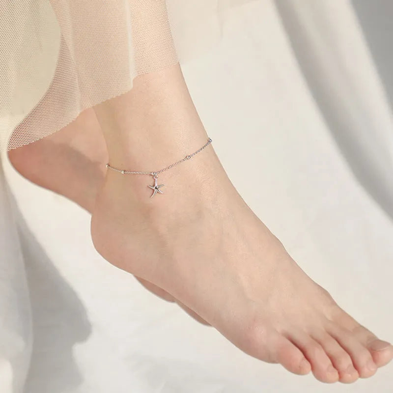 S925 sterling silver adjustable starfish anklet with round beads on an ankle, showing the 1.2 cm charm detail.
