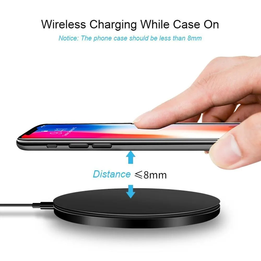 Black ultra-thin square wireless charging pad with USB cable on a desk.