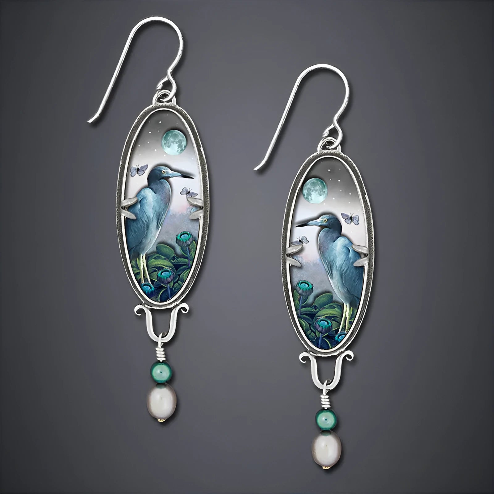 Silver drop earrings with a detailed bird and flower motif on a retro design.