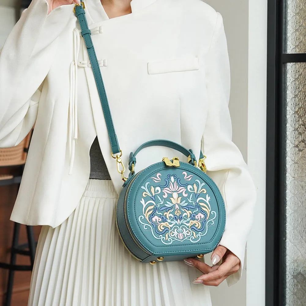 Round PU crossbody bag with embroidery, peacock blue colour, small size, front view
