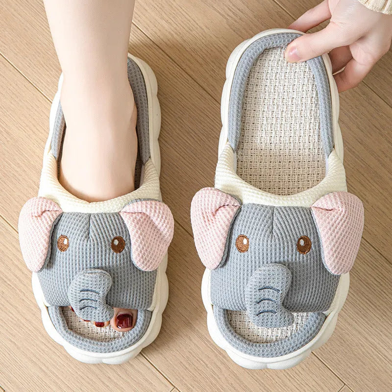 Elephant grey open-toe linen slippers for couples on a plain background, showing animal pattern detail and sewn sole.
