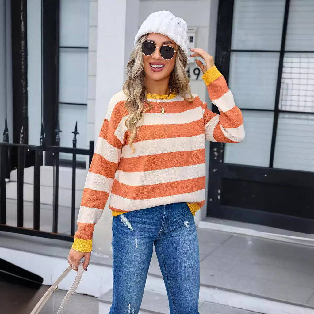 Loose fit blue women's acrylic sweater with round neck and long sleeves laid flat.