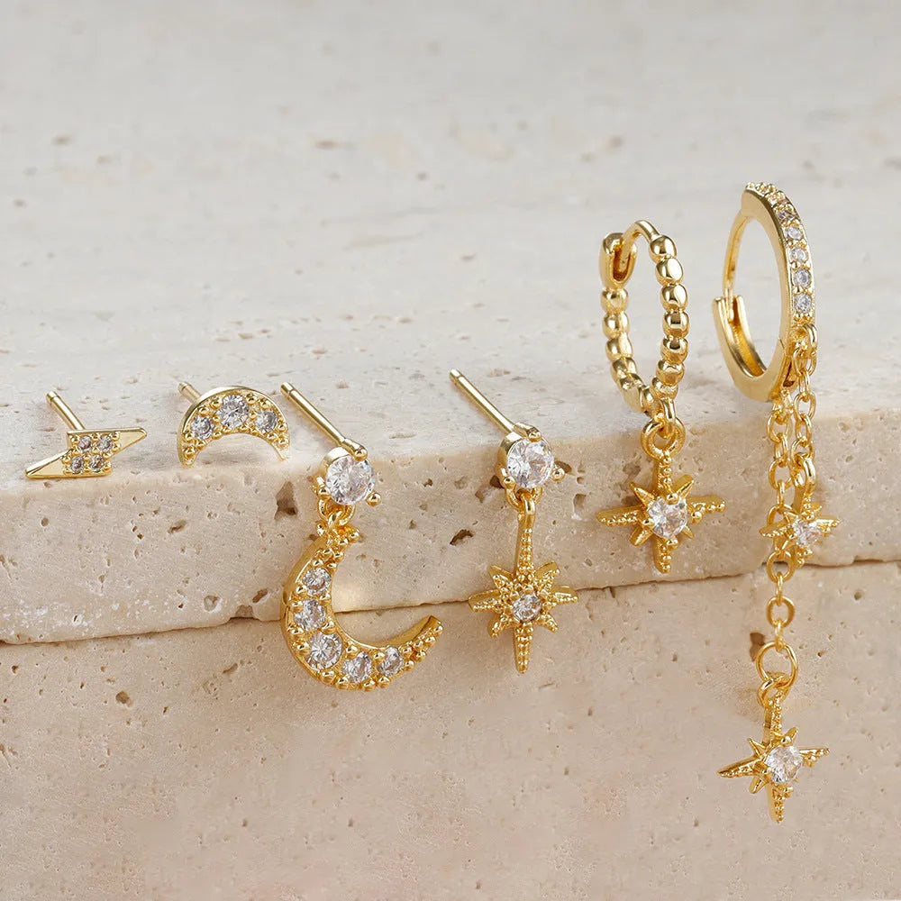 Six gold-coloured chain tassel earrings with zircon stones arranged together