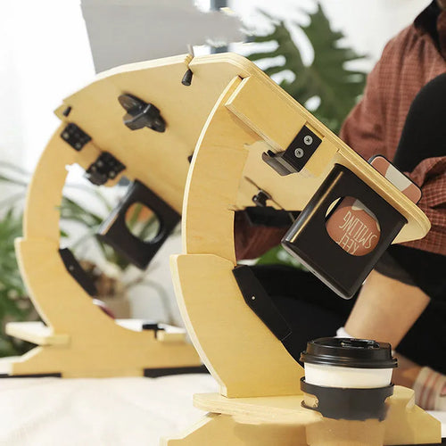 White maple wooden bed table holding a laptop at an angle, folded legs visible on a duvet.