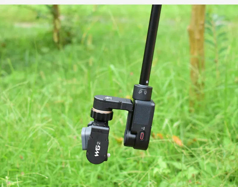 Black retractable aluminium selfie stick extended to its full 1-metre length with a universal phone mount attached.