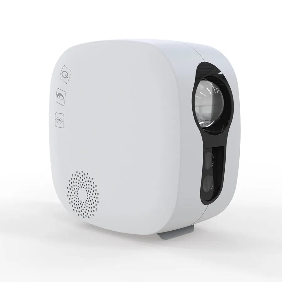 Black cube laser star projector showing nebula and moon display on a wall.