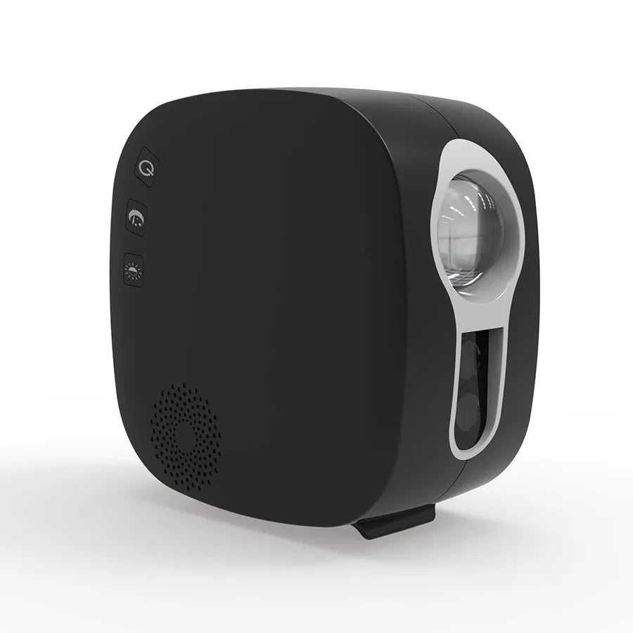 Black cube laser star projector showing nebula and moon display on a wall.