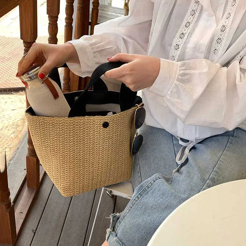 Casual rattan straw shoulder bag in black, bucket shape with shoulder strap