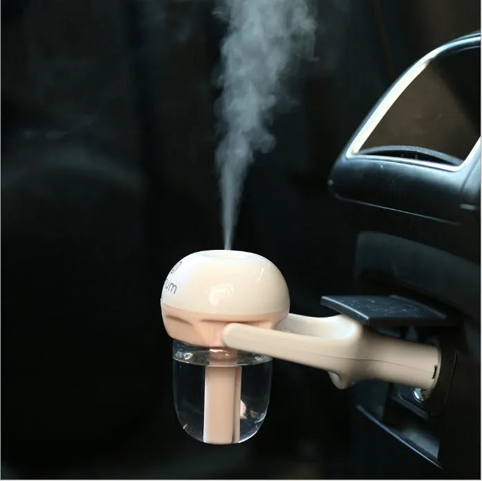 Blue portable car humidifier with rotating nozzle on a car dashboard