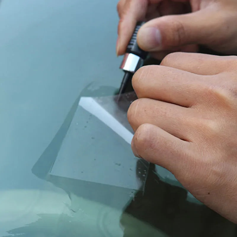 Yellow car windscreen repair kit with UV resin bottle, injection tool, and curing lamp for DIY glass crack repair