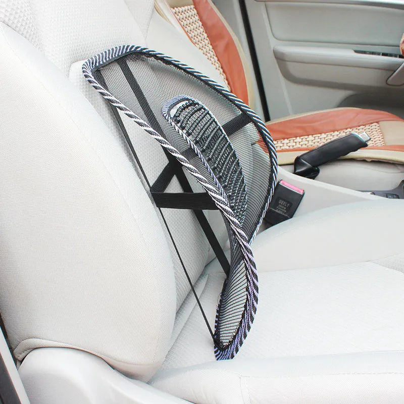 Black car lumbar support pillow with mesh cover on a car seat.