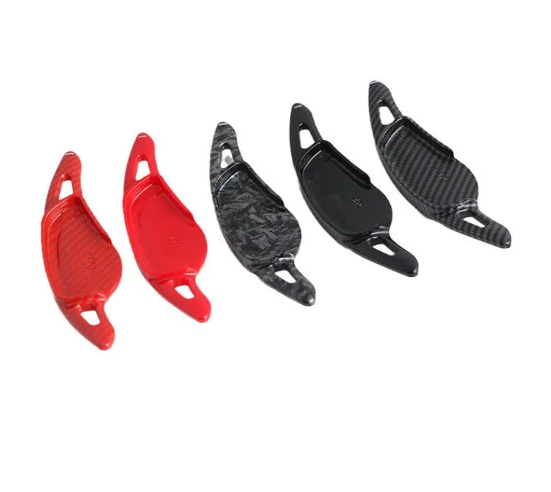 Steering wheel paddle shifters in carbon fibre black finish for manual gear control enhancement