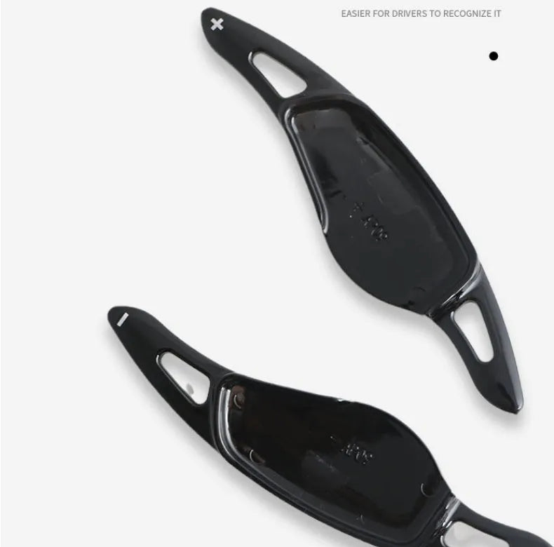Steering wheel paddle shifters in carbon fibre black finish for manual gear control enhancement