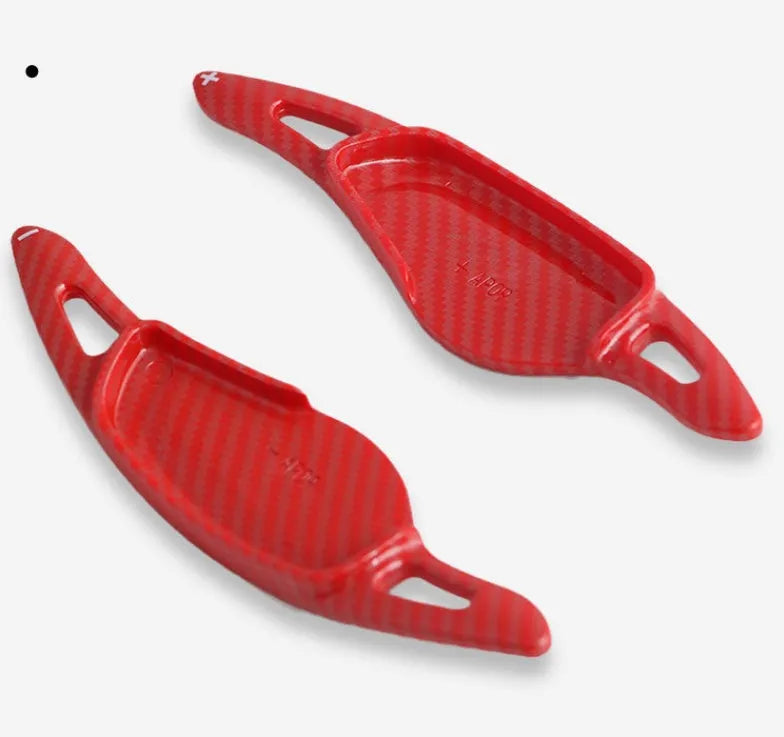 Steering wheel paddle shifters in carbon fibre black finish for manual gear control enhancement