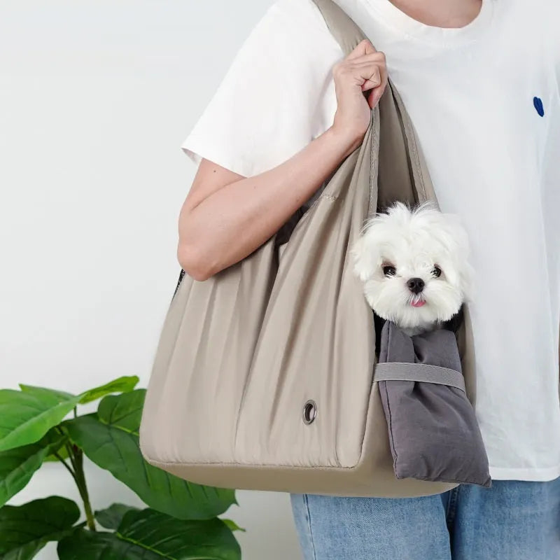 Apricot coloured cloth pet handbag carrier for cats or small dogs.