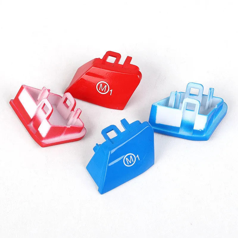 Pair of red and blue BMW M1 and M2 steering wheel mode buttons on a white background.