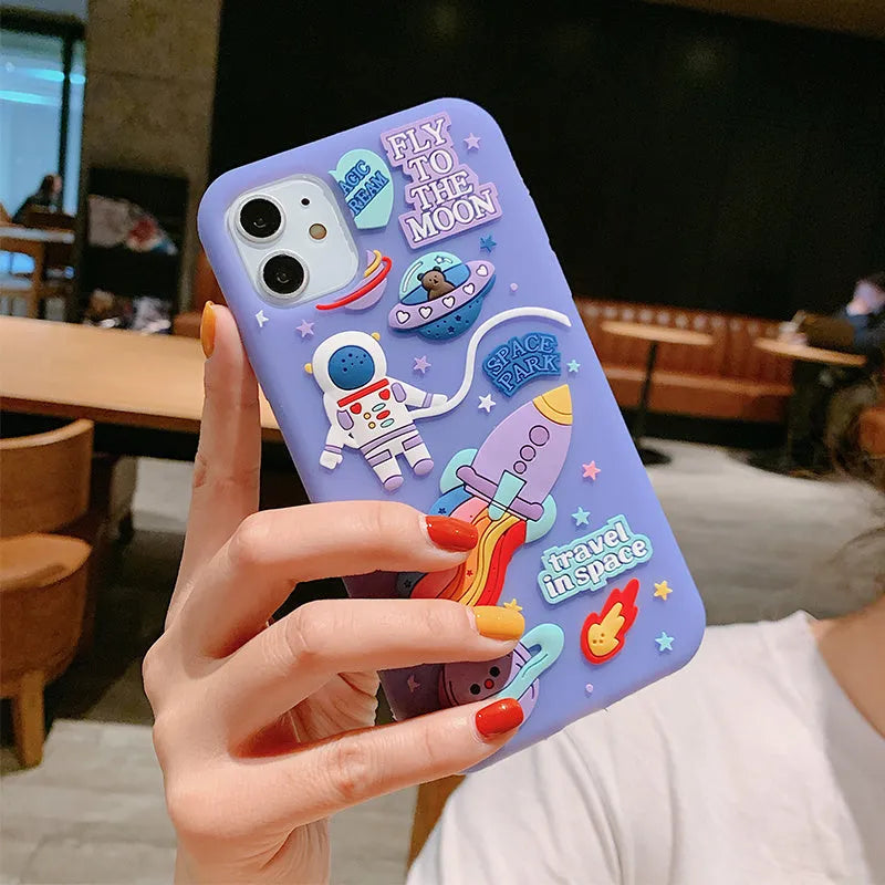 Purple silicone iPhone case with a detailed cartoon astronaut design on the back.