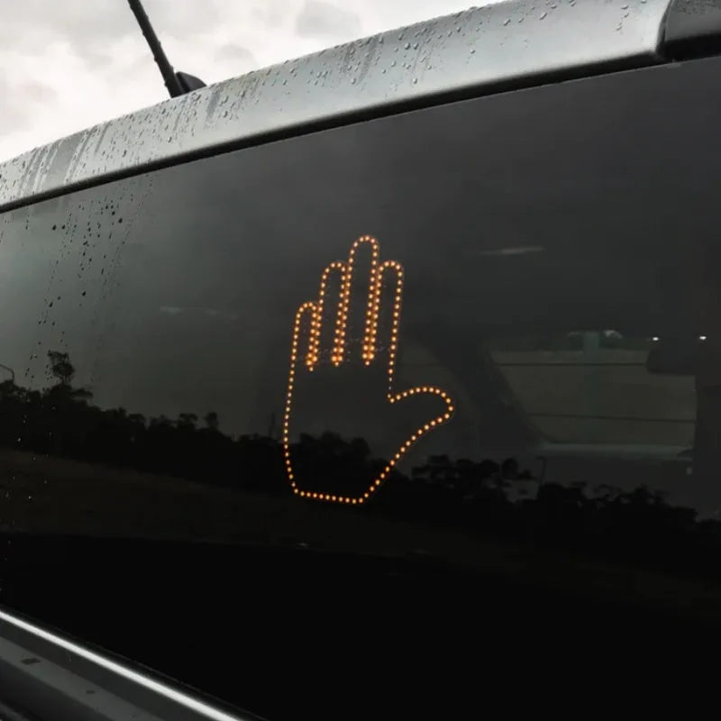 Black plastic LED gesture light for cars with remote control showing middle finger symbol