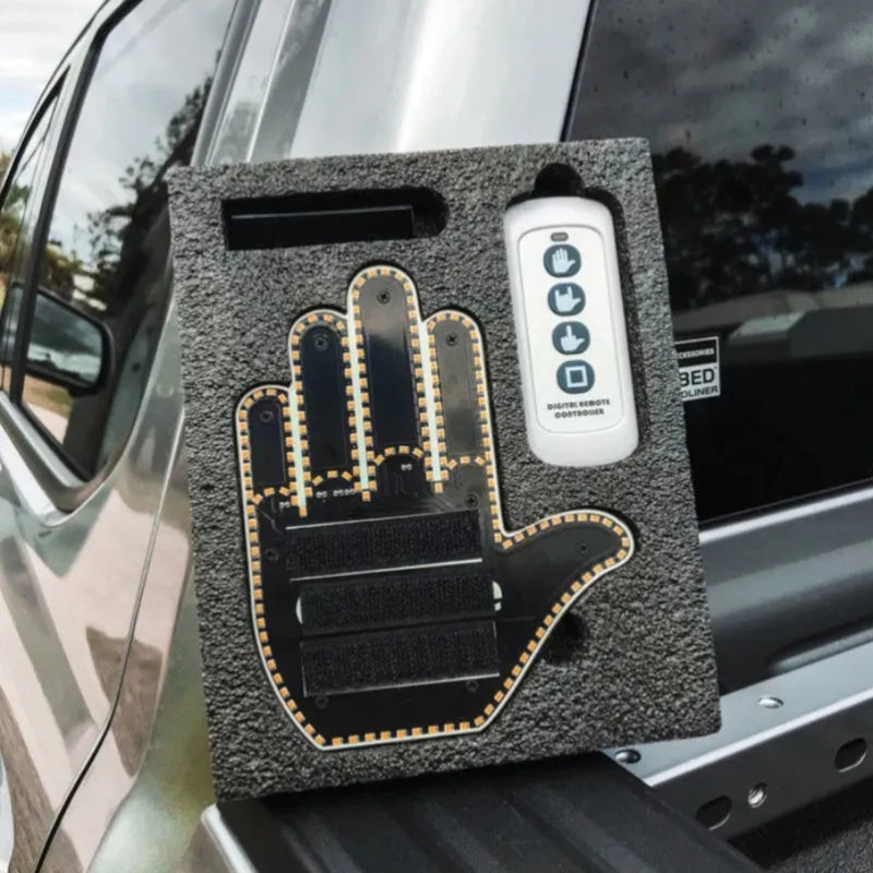 Black plastic LED gesture light for cars with remote control showing middle finger symbol