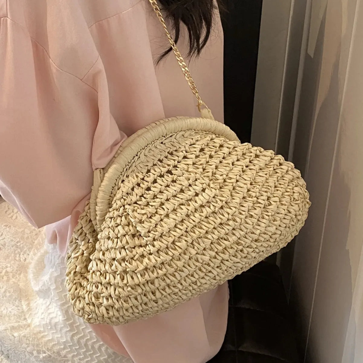 Women's khaki shell-shaped straw shoulder bag with a chain strap detail