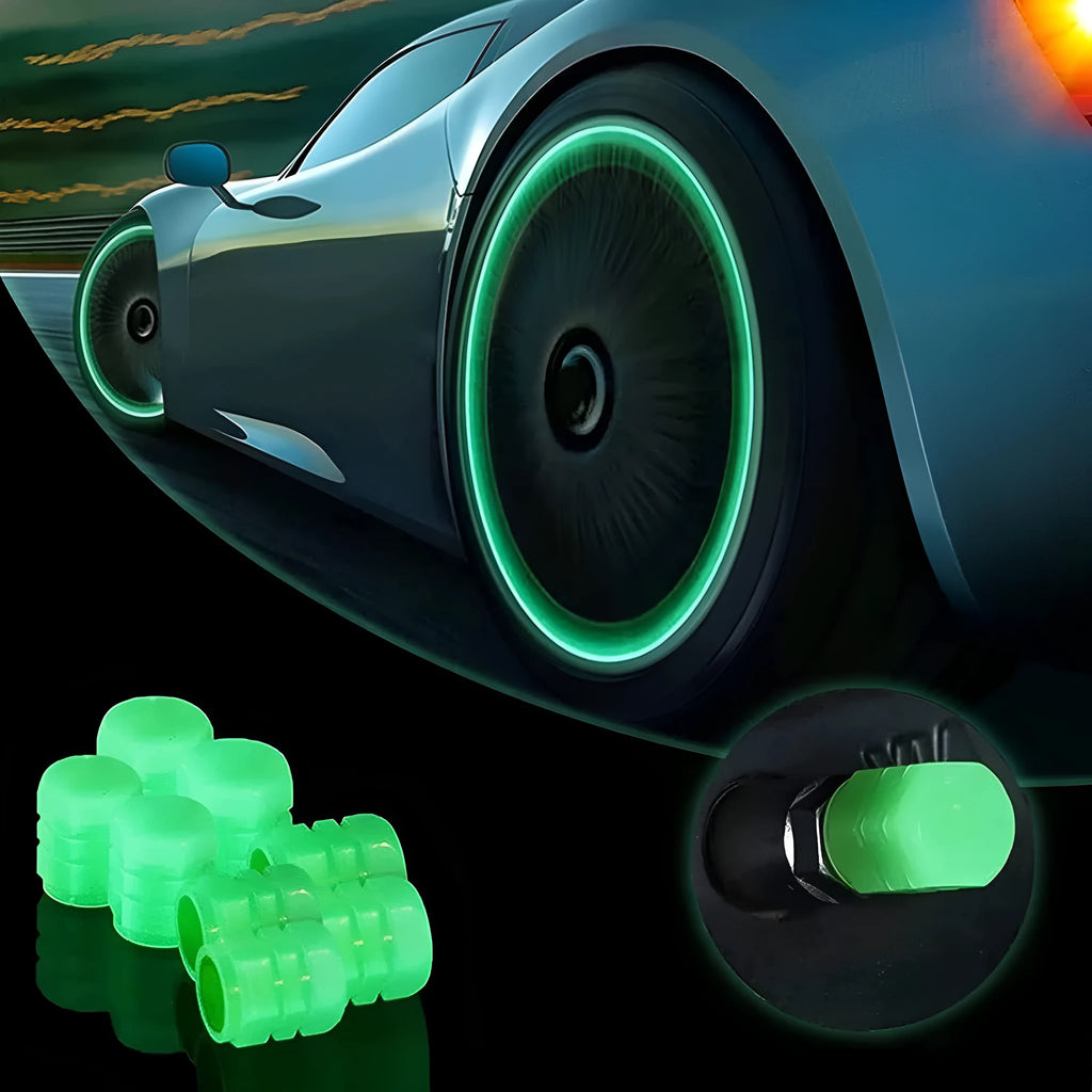 Set of four glowing green LED tyre valve caps screwed onto a car wheel valve stems at night.