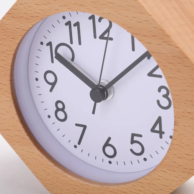 Wooden hexagonal alarm clock with luminous dial and beech finish on a nightstand
