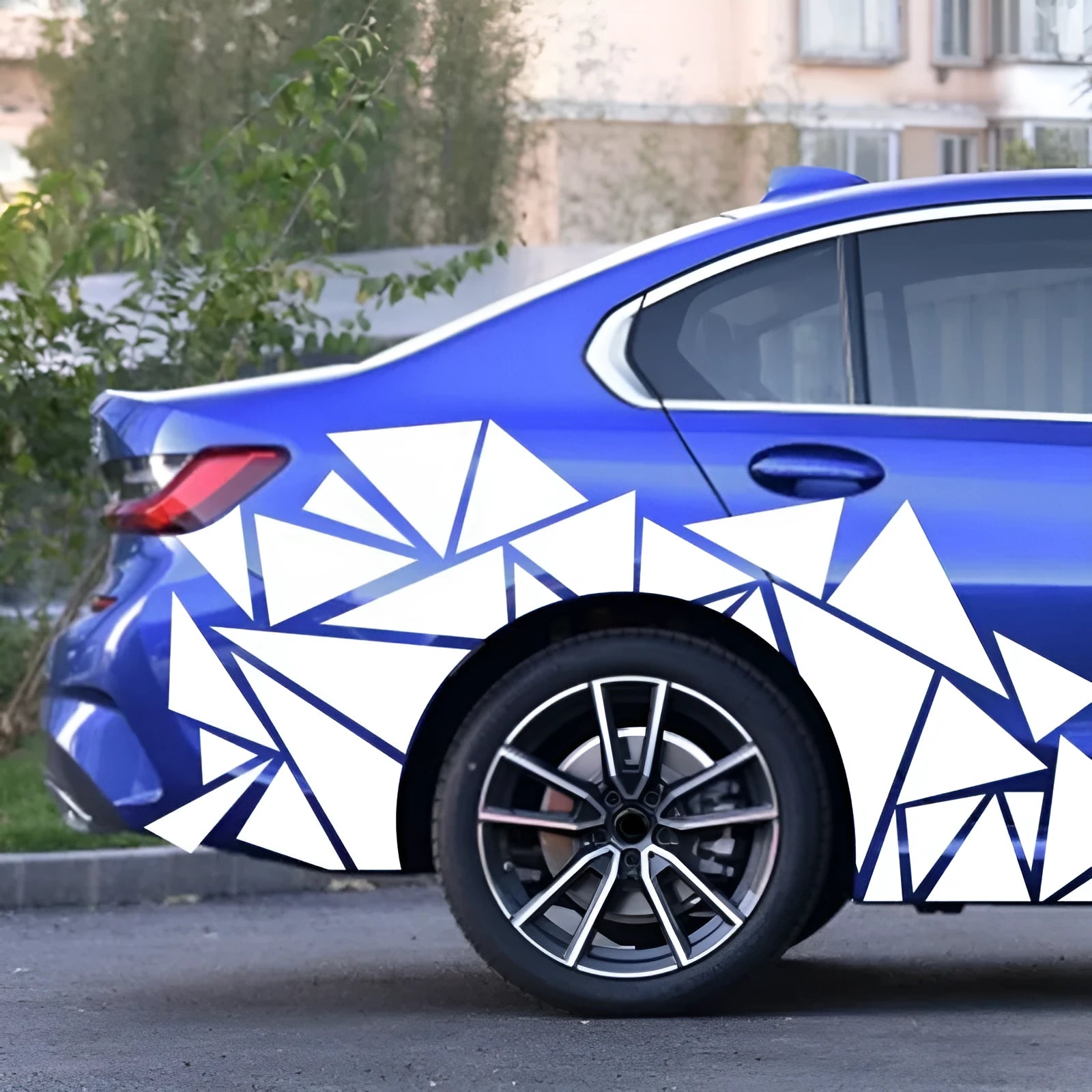 Long black geometric pattern car sticker laid flat, showing its 200cm length for wheel arch application.