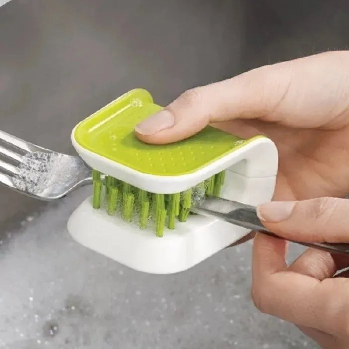 Blue U-shaped plastic brush for cleaning knives and forks in kitchen sink